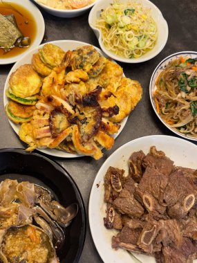 Warm and comforting jibbap (home-cooked Korean meal) with a spread of rice, soup, and banchan, offering a perfect harmony of flavor, tradition, and heartwarming nourishment in every bite.