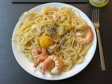 Creamy spaghetti carbonara made with rich egg yolk sauce, crispy bacon, parmesan cheese, and freshly ground black pepper for a classic, indulgent Italian pasta dish.