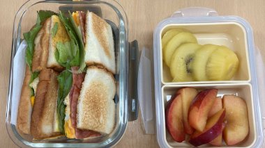 Bento or dosirak box filled with rice, assorted side dishes, vegetables, and protein like meat or fish, all neatly arranged to create a balanced, colorful, and visually appealing meal