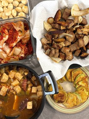 Warm and comforting jibbap (home-cooked Korean meal) with a spread of rice, soup, and banchan, offering a perfect harmony of flavor, tradition, and heartwarming nourishment in every bite.