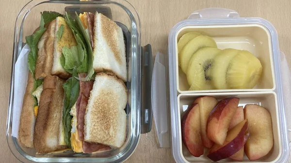 Bento or dosirak box filled with rice, assorted side dishes, vegetables, and protein like meat or fish, all neatly arranged to create a balanced, colorful, and visually appealing meal