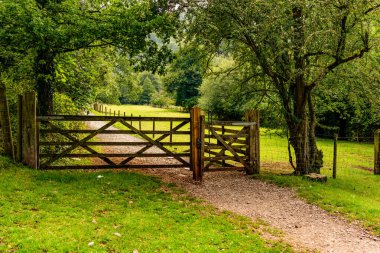 Rustic Countryside Gate Leading to a Peaceful Meadow Path