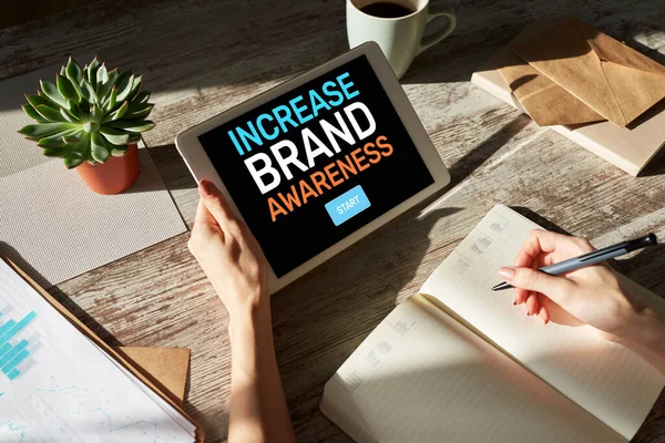 Increase brand awareness text on screen. Advertising and marketing concept