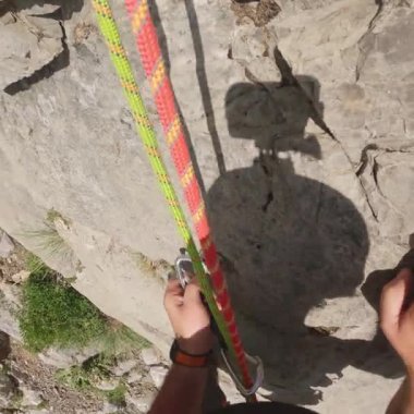 Kaya tırmanışçısının POV Hızla Halatı İndirirken İpi Çözüyor