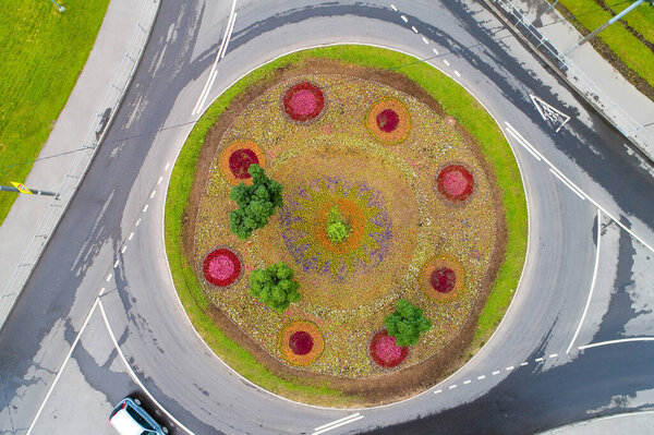 Top view of a flower bed and a roundabout road. Aerial photography.