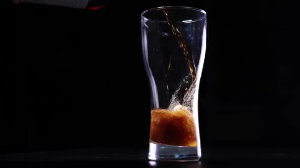 Pouring cola into a glass in slow motion — Stock Video