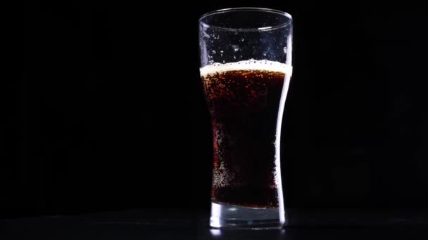 Pouring cola into a glass in slow motion — Stock Video