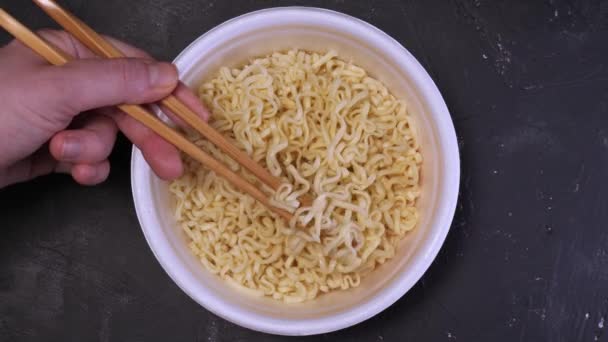Girls hands take the noodles with chopsticks and think up — Stock Video