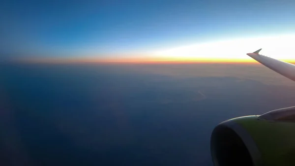 View from the plane to the wing and sunset — Stock Photo, Image