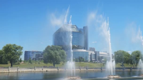 Minsk Belarus juni 2021. Nationale Bibliotheek tegen de achtergrond van de slow mo fonteinen — Stockvideo