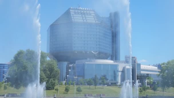 Minsk Belarus juni 2021. Nationale Bibliotheek tegen de achtergrond van de slow mo fonteinen — Stockvideo