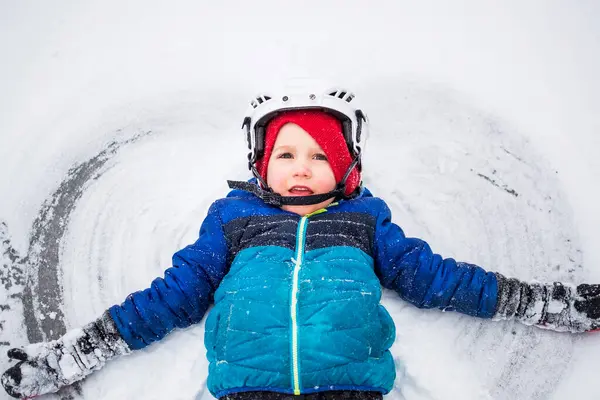 Boy Lying Frozen Lake Making Snow Angel Wisconsin United States — Stock Photo, Image