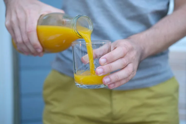 Man Pouring Glass Orange Juice — Stock Photo, Image