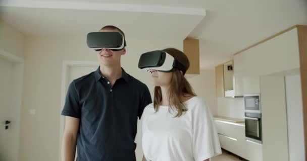 Young Couple Wearing Headsets New Apartment Young Man Woman Viewing — Vídeo de Stock