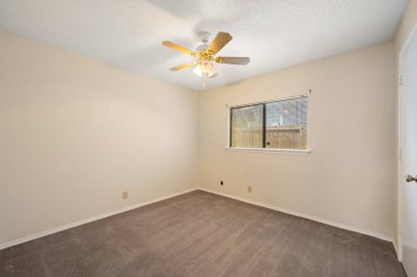 Üst kata çıkan zarif merdivenlerle birlikte davetkar bir şöminenin bulunduğu geniş ve boş bir oturma odası, rahat bir atmosfer yaratıyor.