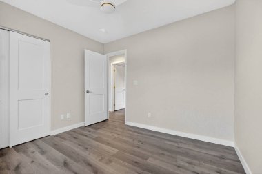 Karanlık Ahşap Döşemeli Boş Yatak Odası, Beyaz Dolap Kapıları, Tavan Pervanesi, Tarafsız Bej Duvarlar, Doğal Işık Duvarları