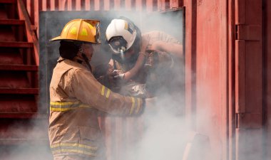 İki itfaiyeci, duman dolu bir binadan genç bir kızı kurtarıyor. Olay yerini yoğun duman sarmış durumda. Müdahale ekipleri çocuğu güvenli bir şekilde tehlikeden kurtarmak için birlikte çalışıyorlar.