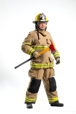Tam donanımlı bir itfaiyeci, beyaz bir arka plana karşı bir kurtarma baltası ile güvenle ayakta duruyor.
