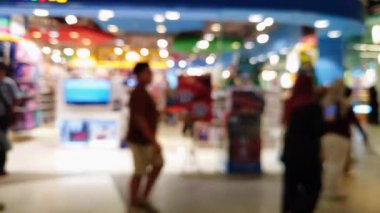 Kalabalık alışveriş merkezi, modern yaşam tarzı için odaksız bokeh ile yürüyen insanların ve arkadaşlarının bulanıklığını gösteriyor..