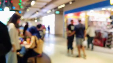 Mutlu hafta sonu aktiviteleri, şehir hayatı konsepti için odaklı olmayan bir mimariyle alışveriş merkezinde yürüyen insanları bulanık gösteriyor..