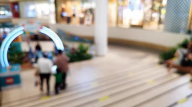 Ailesiyle gezen ve ticari kullanım için parlayan vitrinleri kapatan insanların bulanık görüntülerinin yer aldığı sinematik görüntüler.