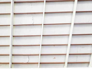 İhmal edilmiş bir binanın iç kısmındaki çatlamış tavanı kahverengi levhalarla kapatın.