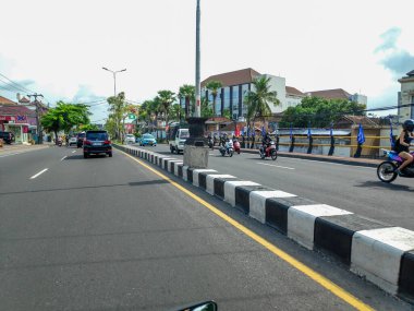 Local people walking amidst the quiet traffic in denpasar city area Bali, Indonesia 17 April 2025