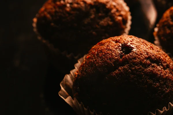 Muffin al cioccolato con noci su sfondo scuro, focus selettivo — Foto Stock