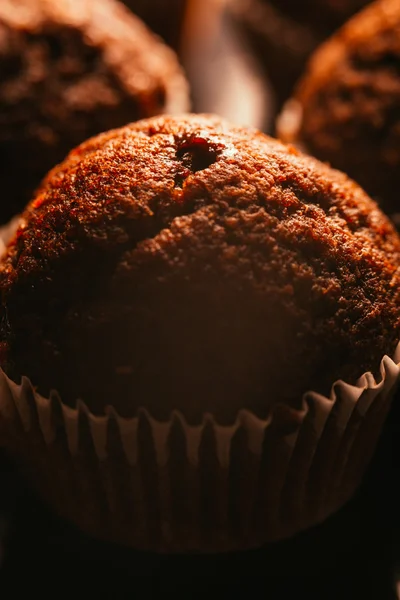 Chocolate muffins with nuts on dark background, selective focus — Stock Photo, Image