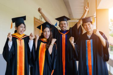Mezuniyet elbisesi ve havan topu şapkasıyla mezun olan Asya Üniversitesi mezuniyet töreninde elde elde eğitim başarısını kutluyor. Mezuniyetleri kutlarım.
