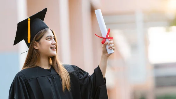 Young Happy Asian Woman University Graduate Graduation Gown Mortarboard Holds — Stock Photo, Image