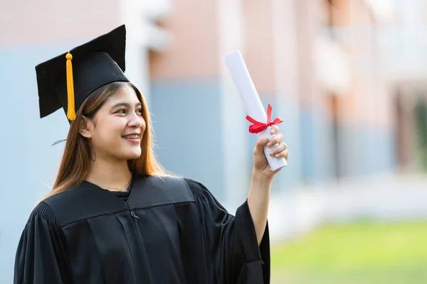 Young Happy Asian Woman University Graduate Graduation Gown Mortarboard Holds — Stock Photo, Image