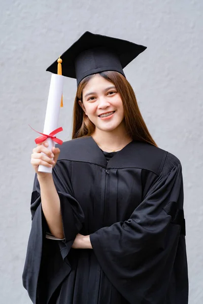 Young Happy Asian Woman University Graduate Graduation Gown Mortarboard Holds — Stock Photo, Image