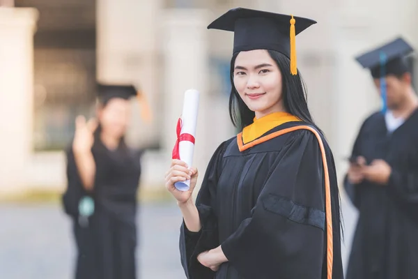 Young Asian Woman University Graduate Graduation Gown Mortarboard Holds Degree — Stock Photo, Image