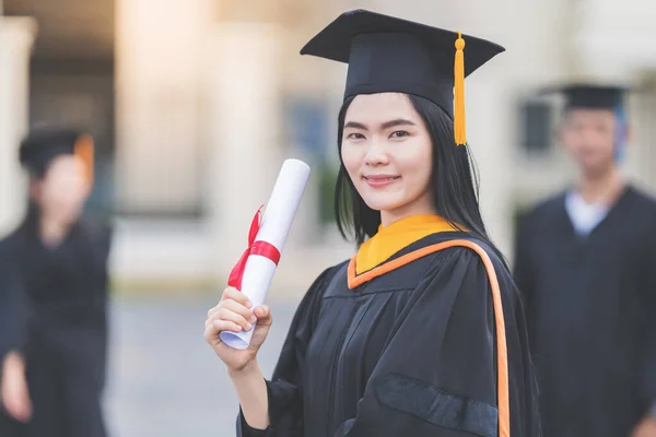 Young Asian Woman University Graduate Graduation Gown Mortarboard Holds Degree — Stock Photo, Image