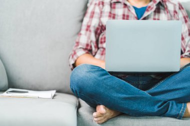 Cropped close-up image of a businessman`s hands typing working on a laptop at the home office. Freelancer, remote occupation, tutor, student e-learning concept