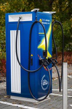 Wroclaw, Poland- 23 Ekim 2025: Lidl markalı elektrikli araç şarj istasyonu sonbahar günü süpermarketin yanındaki otoparkta bulunuyor. Temiz enerji ve modern şehir altyapısı