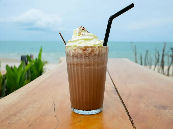 Chocolate frappe or chocolate ice blended with whipped cream on wooden table