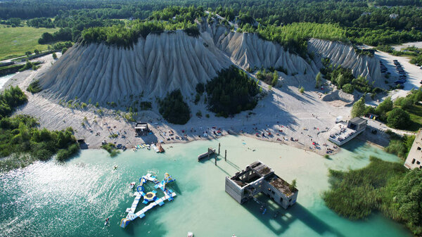 Aerial View of Scenic Blue Lake Beach with Sand Cliffs and Summer Tourists in Estonia