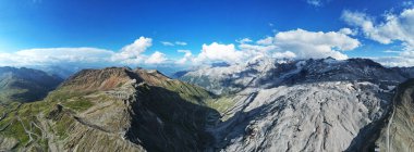 Geniş panoramik dron görüntüsü engebeli tepeleri, dolambaçlı yolları, buzulları ve İtalyan Alpleri 'ndeki ünlü Stelvio Geçidi' ni çevreleyen dramatik alp manzarasını yakalıyor..