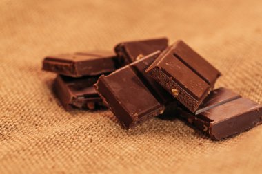 çuval bezi arka plan üzerinde koyu çikolata parçaları