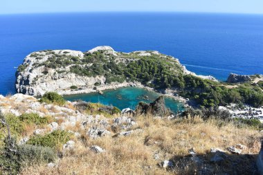Anthony Quinn Bay, Rhodes Island, Greece. View from Anthony Quinn viewpoint. Panoramic sea paradise landscape. Travel to Greece. Summer and holidays. Bird's eye view from above, rocks, clear sea.