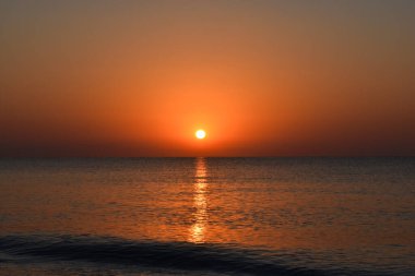 Summer sunrise sea sky landscape, Afandou village, Rhodes Island, Greece. Colorful sea beach sunrise, calm waves. Coast horizon scenic coast view. Tourism and beach holidays. Travel to Greece.