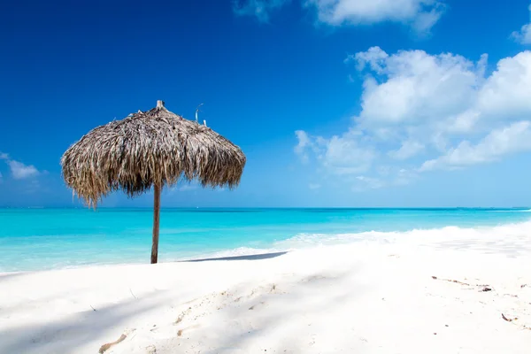 Beach Umbrella on a perfect white beach in front of Sea Stock Photo