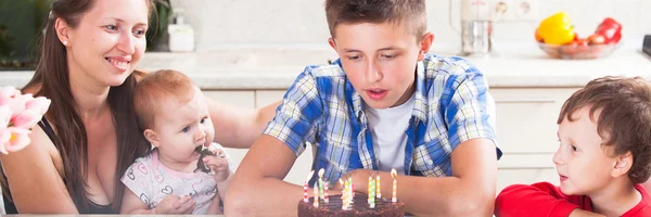 Teenager blows out the candles on a birthday cake