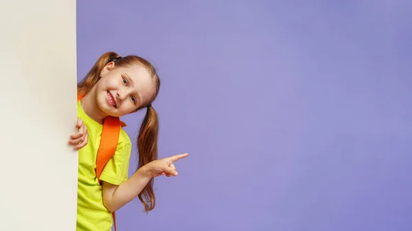 Happy Child Looks Out Wall Points His Finger Side Copying — Stock Photo, Image