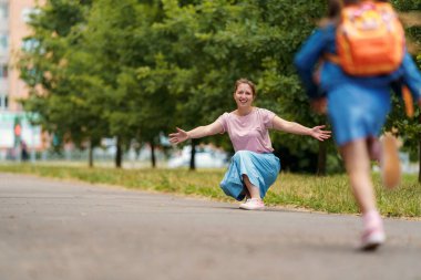 Sevgi dolu aile. Şefkatli anne neşeli çocuklarla tanışır, sırt çantalı kız ve erkek çocukları kollarında koşar, okuldan sonra parkta onlara sarılan çocuklarla tanışır. Okula dönelim. ilk gün eğitimi