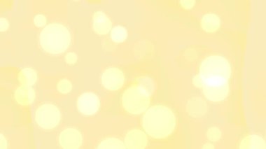Yumuşak sarı bokeh ışık arka planı, parlak dairesel şekiller ve tasarım projeleri için ince gradyanlarla neşeli, nazik ve şen bir atmosfer yaratır..