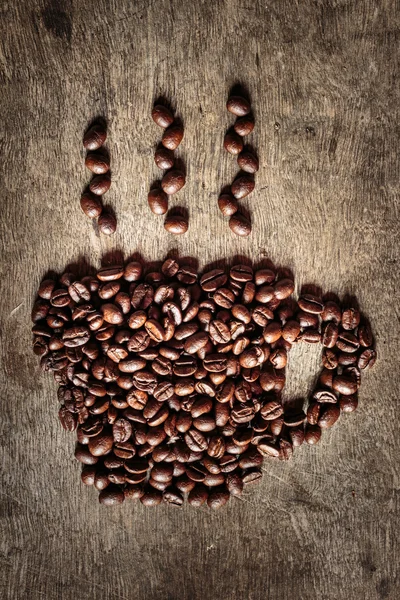 Coffee cup symbol made from coffee beans.