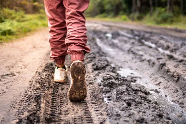 Close up of hiking hikers muddy on forest trail.